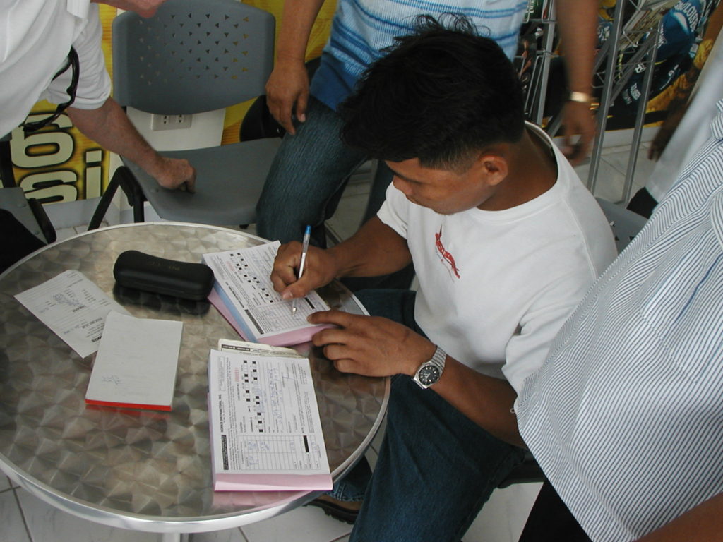 Felisilda signs his name to begin his new life as a tricyle driver in Cagayan de Oro City, Mindanao 